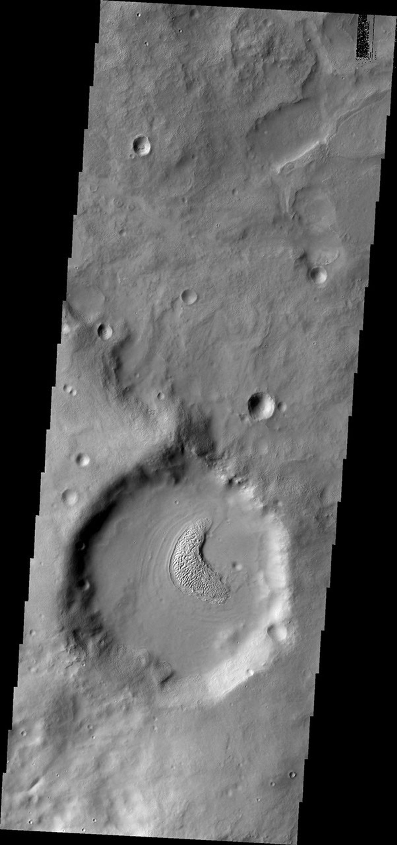 This image from NASA's Mars Odyssey shows a small, unnamed crater in Terra Sabaea containing material on the floor which has developed an unusual texture. This crater is on the northern rim of Flammarion Crater.