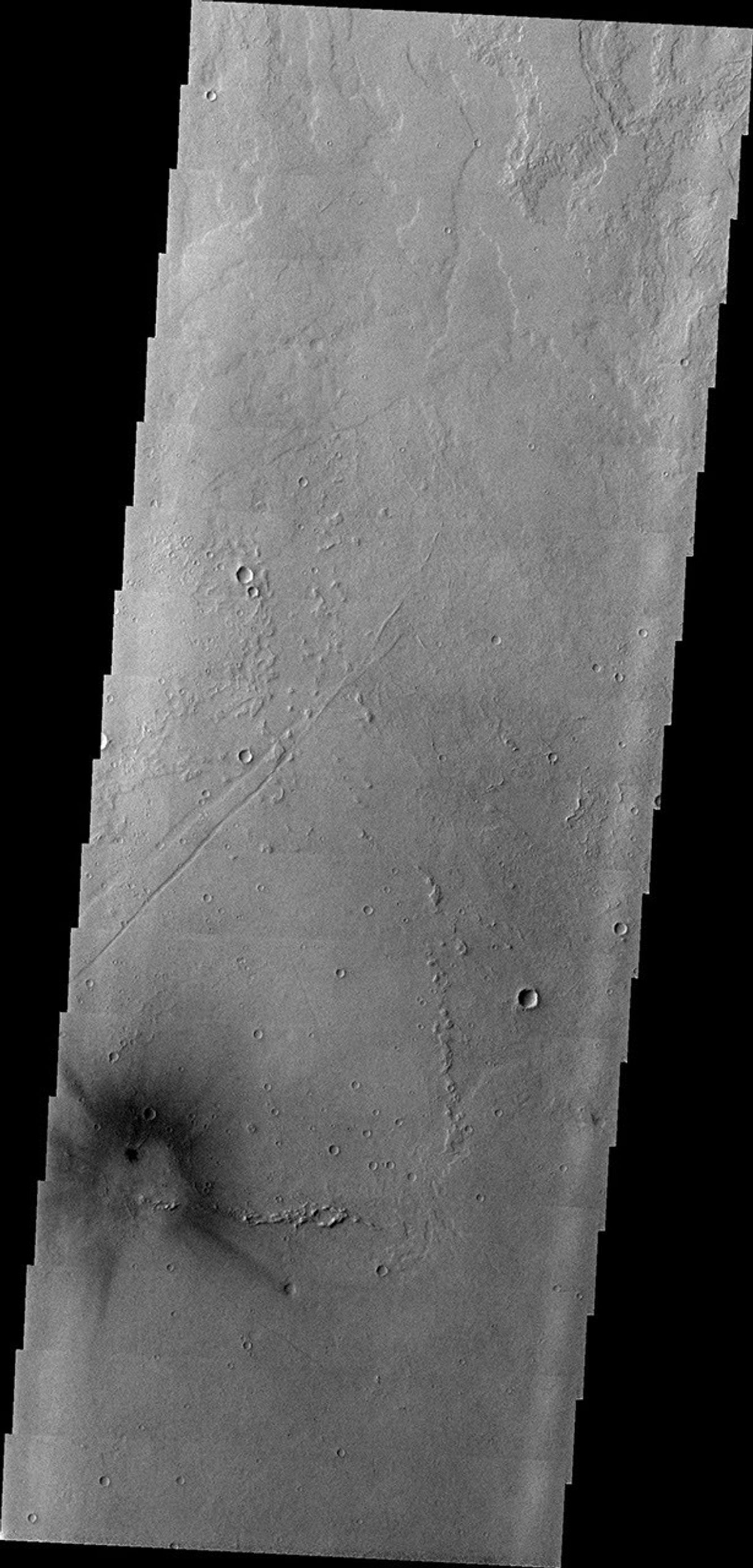 This image from NASA's Mars Odyssey shows a dark, rayed spot east of Jovis Tholus and in the midst of the Tharsis Volcanic field.