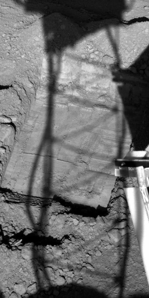 NASA's Phoenix Mars Lander is enlarging a trench informally named 'Snow White' to prepare a cleaned-off area at the top of a subsurface layer of hard material, possibly ice-rich soil on Mars.