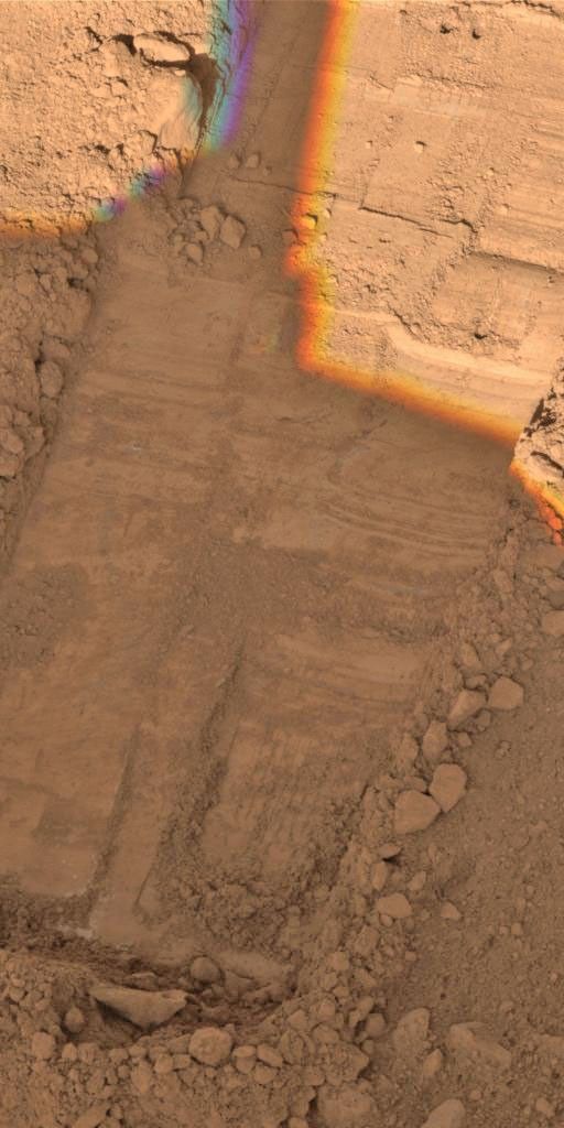 This image, taken by NASA's Phoenix Mars Lander's Surface Stereo Imager on Sol 50, or the 50th day of the mission, July 15, 2008, shows two holes at the top created by the lander's Robotic Arm's motorized rasp tool.