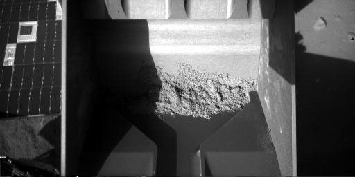 This image from the Robotic Arm Camera on NASA's Phoenix Mars Lander shows that soil remained inside the arm's scoop after an attempt to deliver a soil sample to a laboratory oven on July 26, 2008.