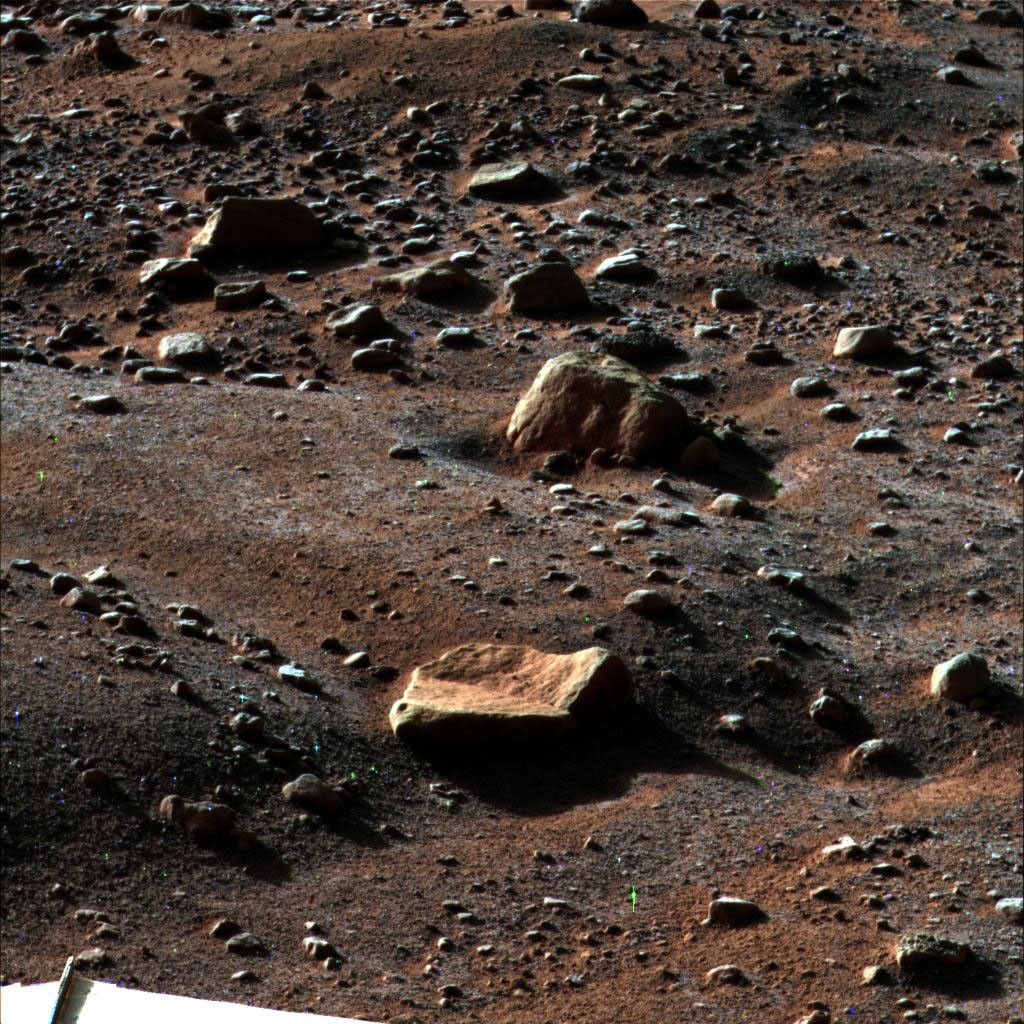A thin layer of water frost is visible on the ground around NASA's Phoenix Mars Lander in this image taken August 14, 2008. Enhanced details of the polygons, troughs and rocks are seen around the landing site.