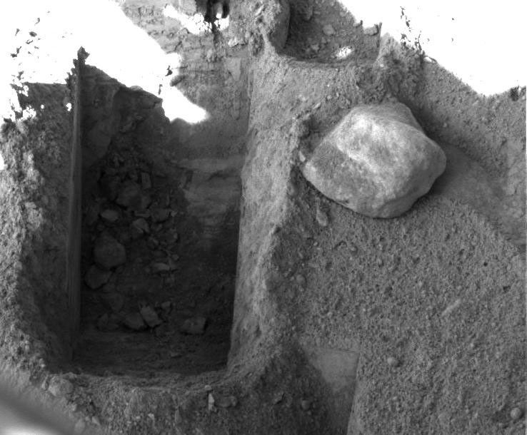 Digging by NASA's Phoenix Mars Lander on Aug. 23, 2008 shows a deep trench, informally called 'Stone Soup' located at the borderline between two of the polygon-shaped hummocks that characterize the arctic plain.