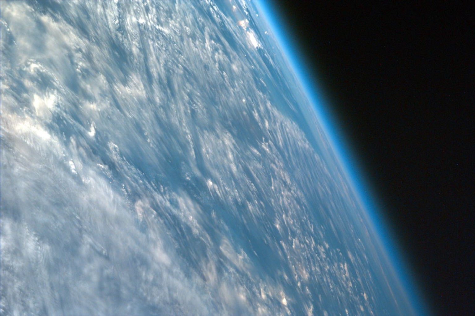 This highly oblique image shot over northwestern part of the African continent captures the curvature of the Earth and shows its atmosphere as seen by NASA's EarthKAM. You can see clouds and even the occasional thunderhead.