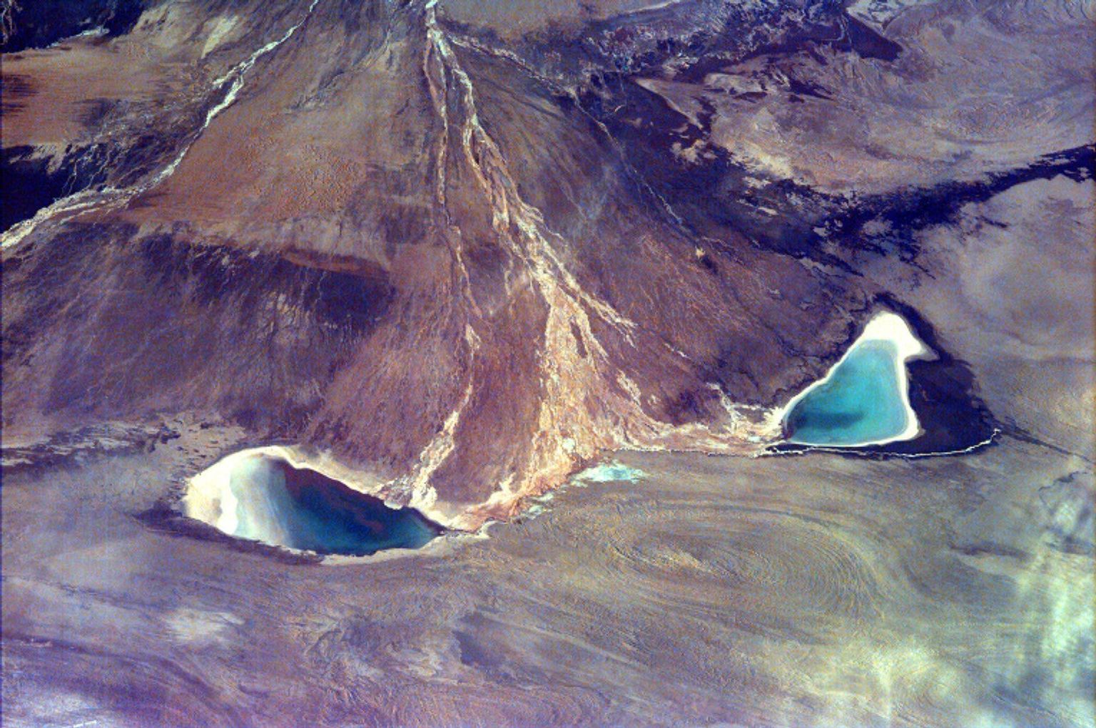 This image captures the beauty of a major alluvial fan in Tsinghai, a province located in Northwestern China. This archival image was taken from NASA's Space Shuttle in 1997 as part of its ISS EarthKAM mission.