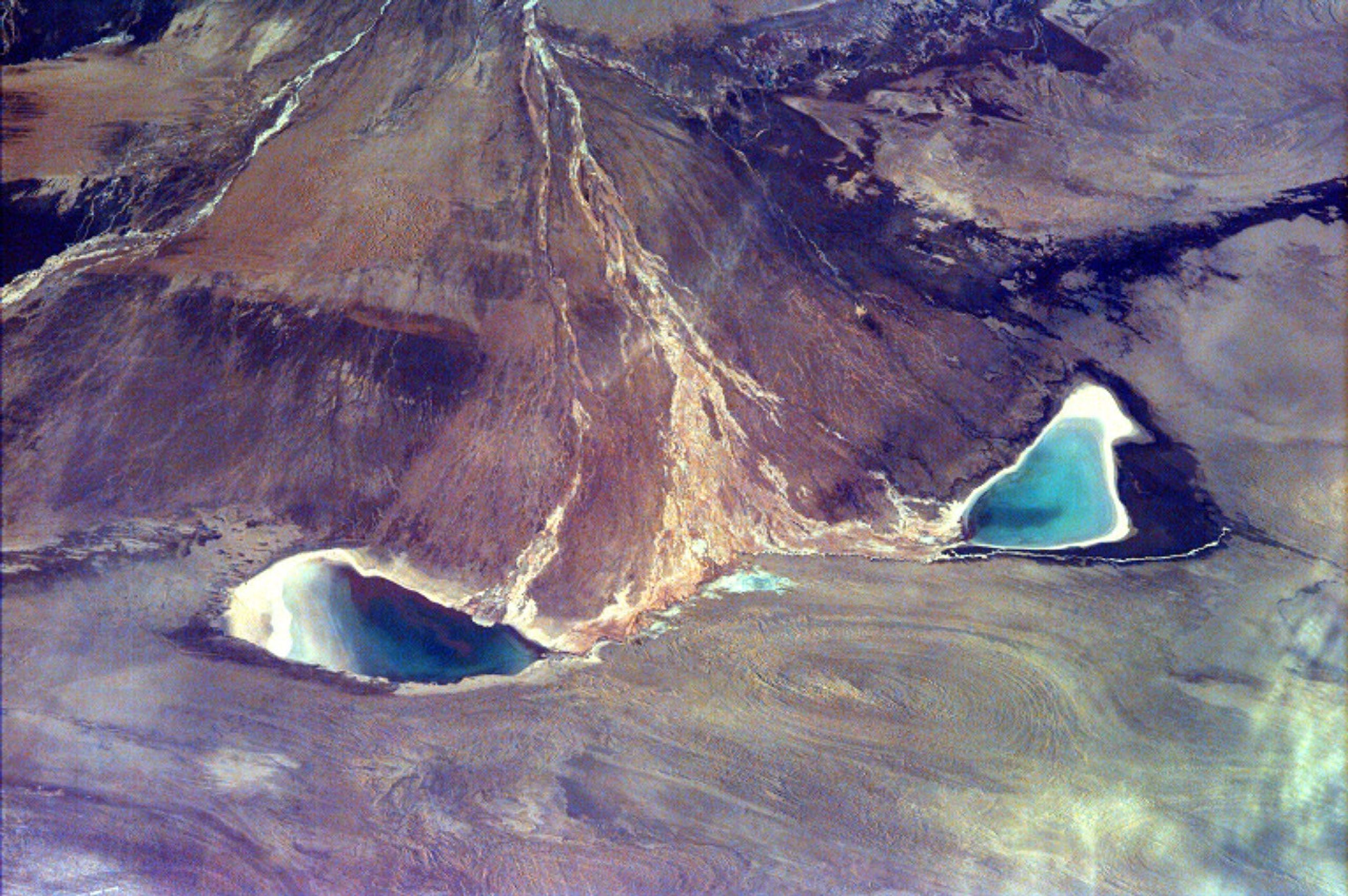 This image captures the beauty of a major alluvial fan in Tsinghai, a province located in Northwestern China. This archival image was taken from NASA's Space Shuttle in 1997 as part of its ISS EarthKAM mission.