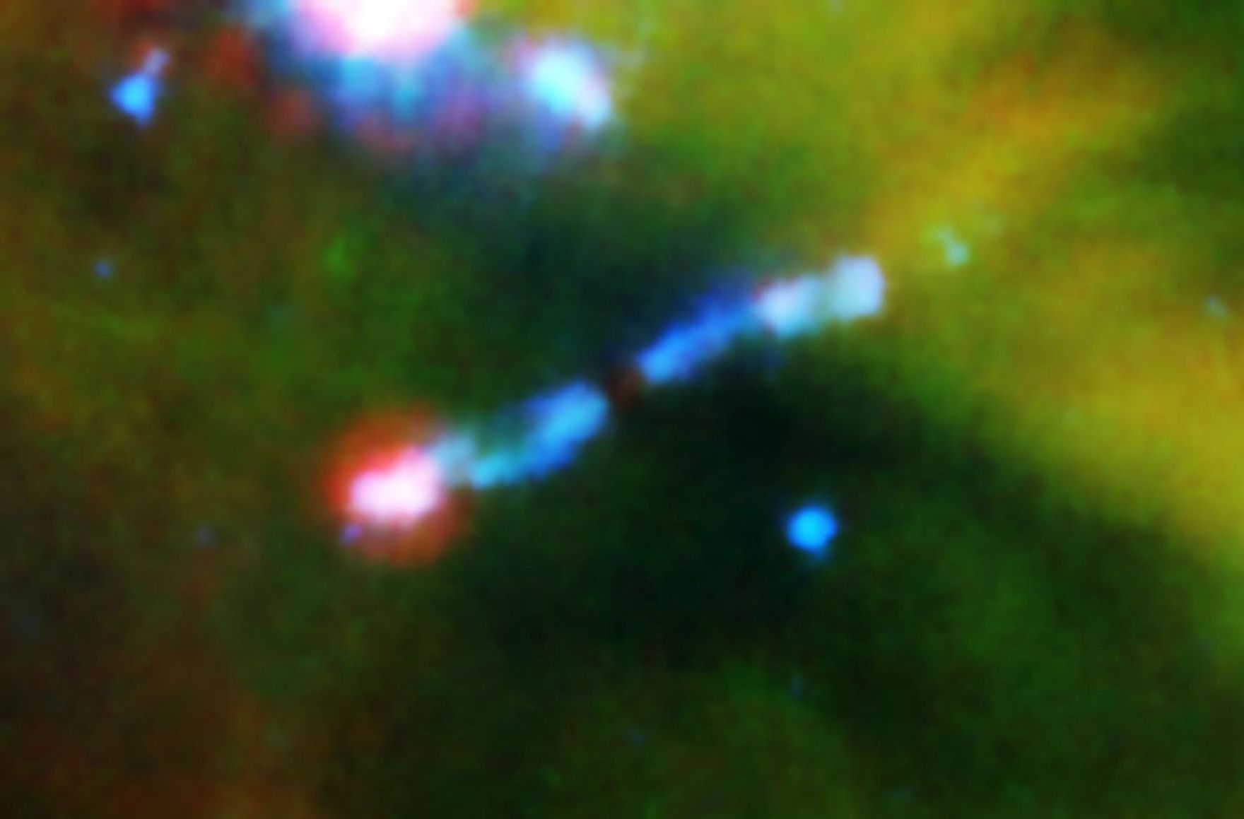 A jet of gas firing out of a very young star can be seen ramming into a wall of material in this infrared image from NASA's Spitzer Space Telescope.