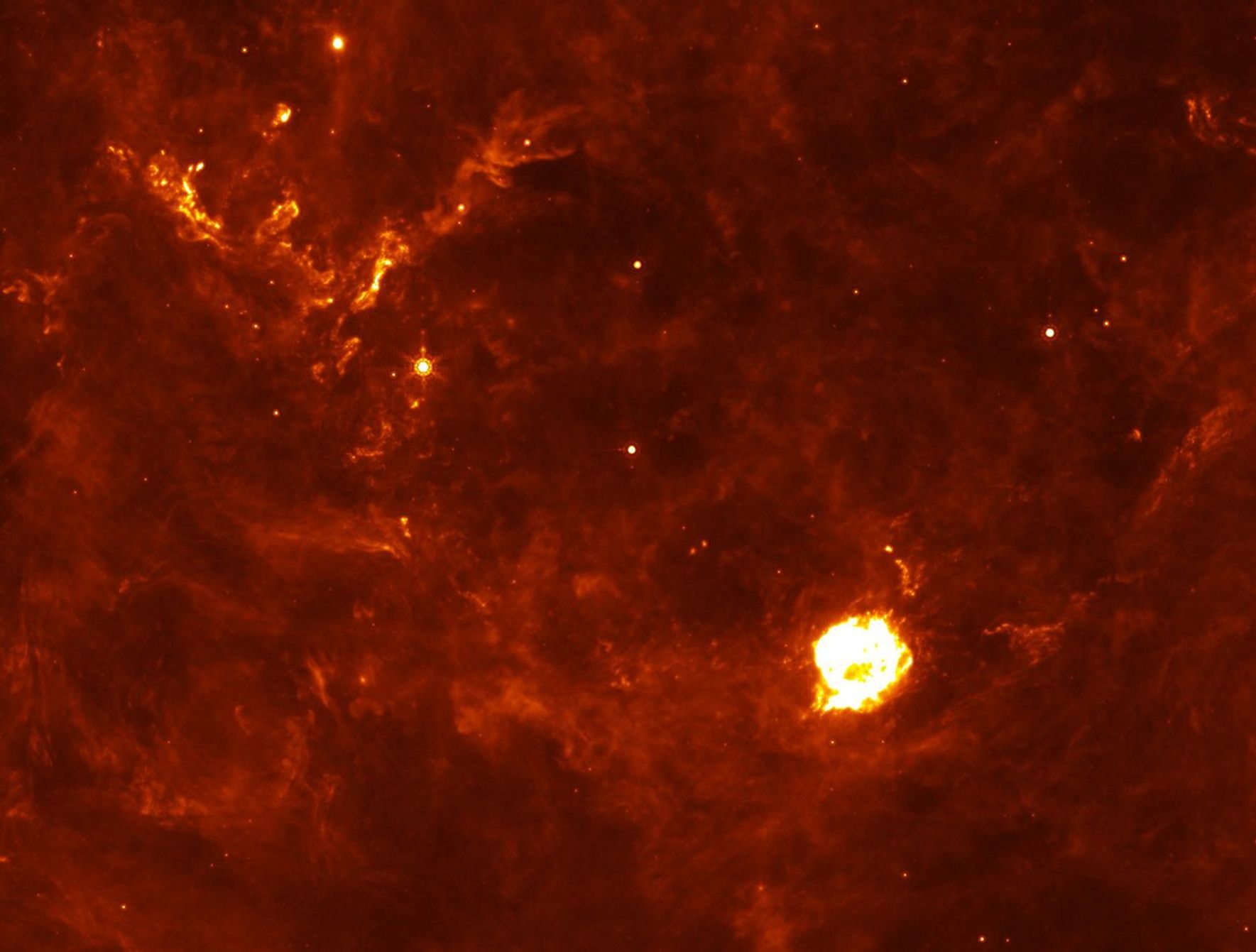 The Cassiopeia A supernova's first flash of radiation makes six clumps of dust (circled in annotated version) unusually hot. The supernova remnant is the large white ball in the center. This infrared picture was taken by NASA's Spitzer Space Telescope.