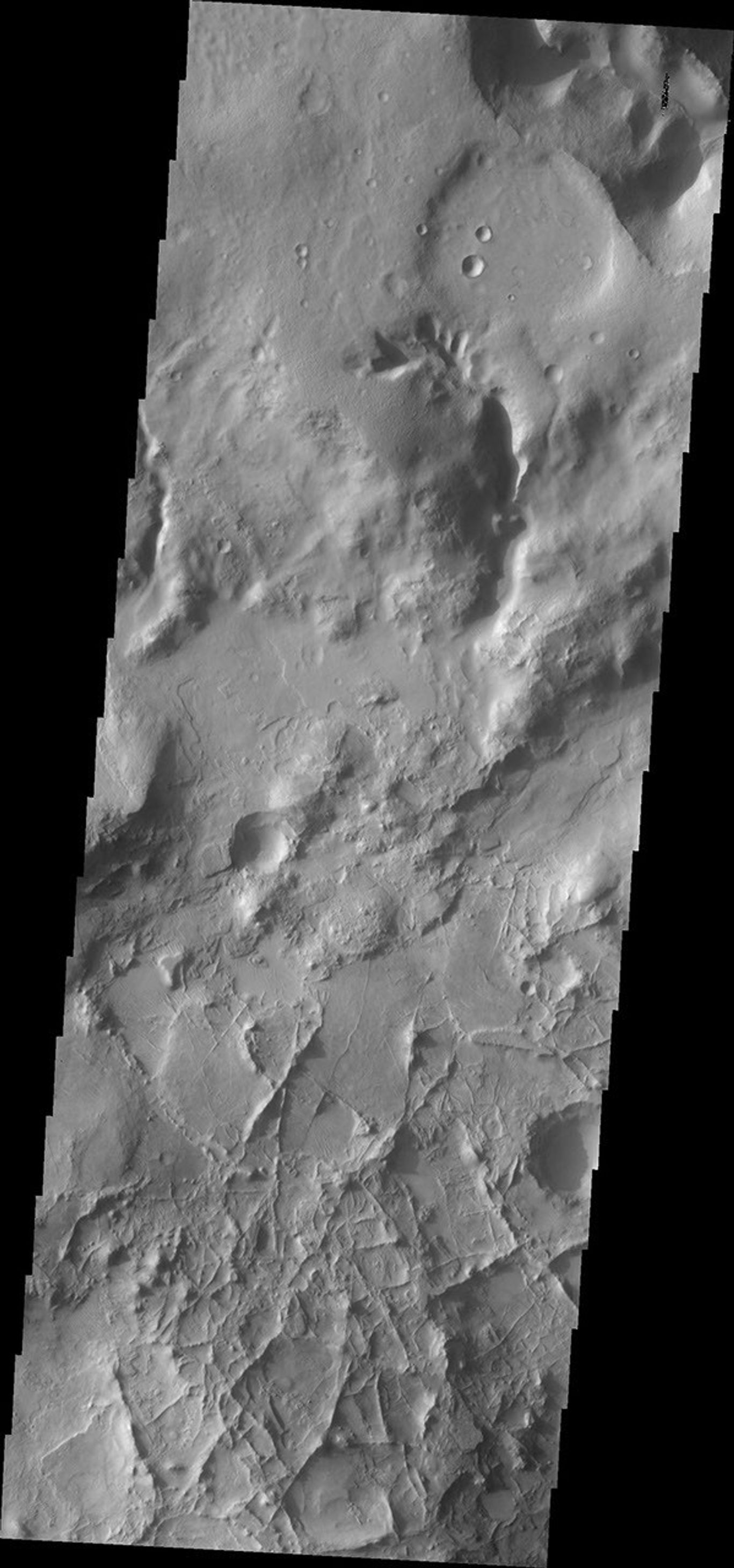 This image from NASA's Mars Odyssey shows a region of crisscrossing linear ridges located just north of Nili Fossae on Mars.