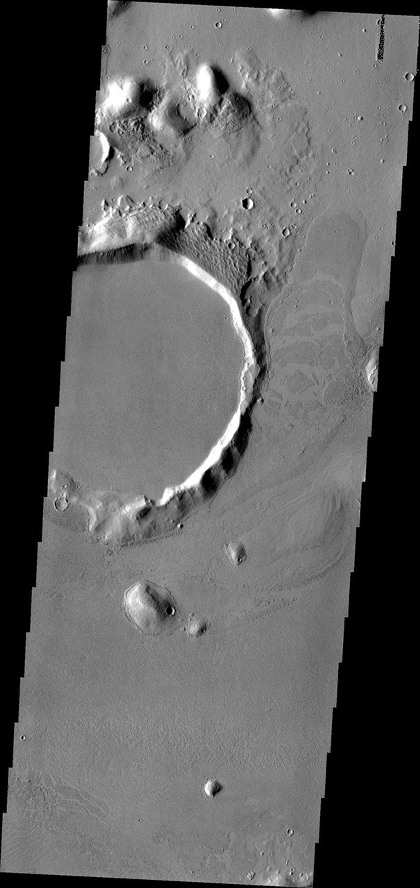 This image from NASA's Mars Odyssey shows the 'tongue' of platy lava located on the eastern side of the crater and spilling towards the north is the margin of an extensive lava field within Amazonis Planitia.