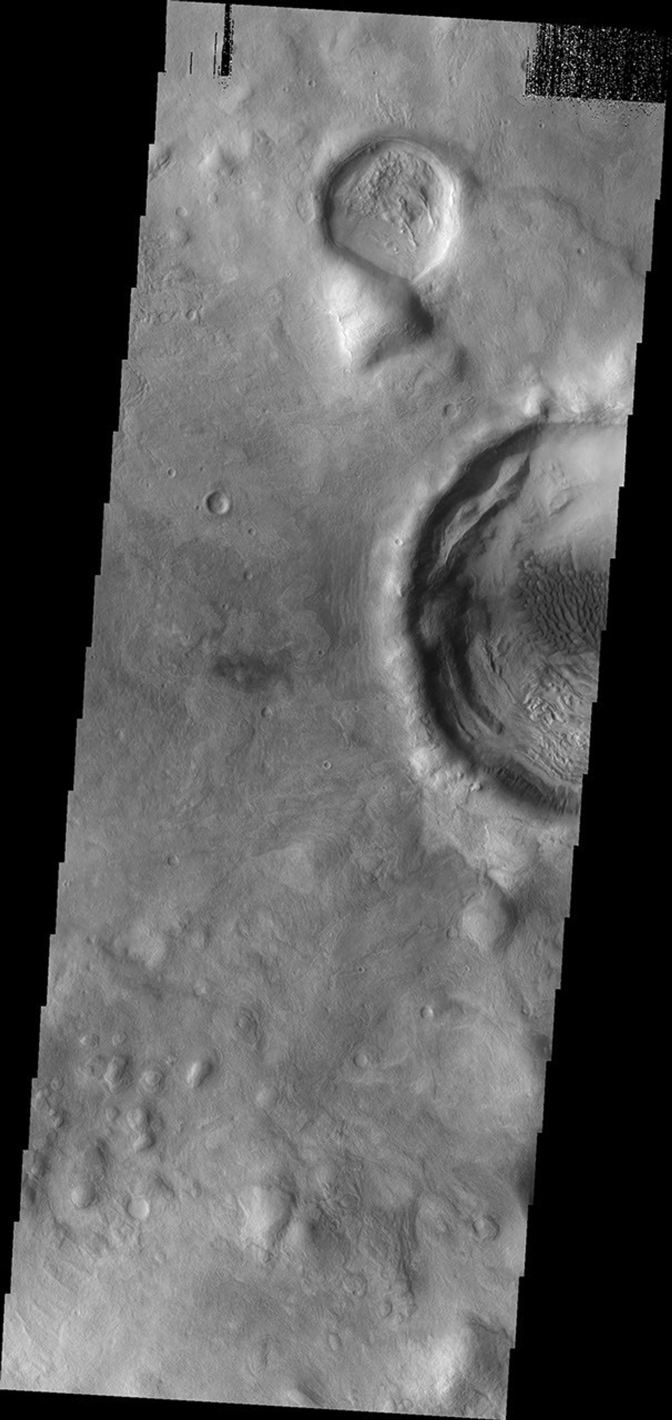 This image from NASA's Mars Odyssey shows dark dunes located on the floor of the unnamed crater just off the eastern margin of Terra Sabaea.