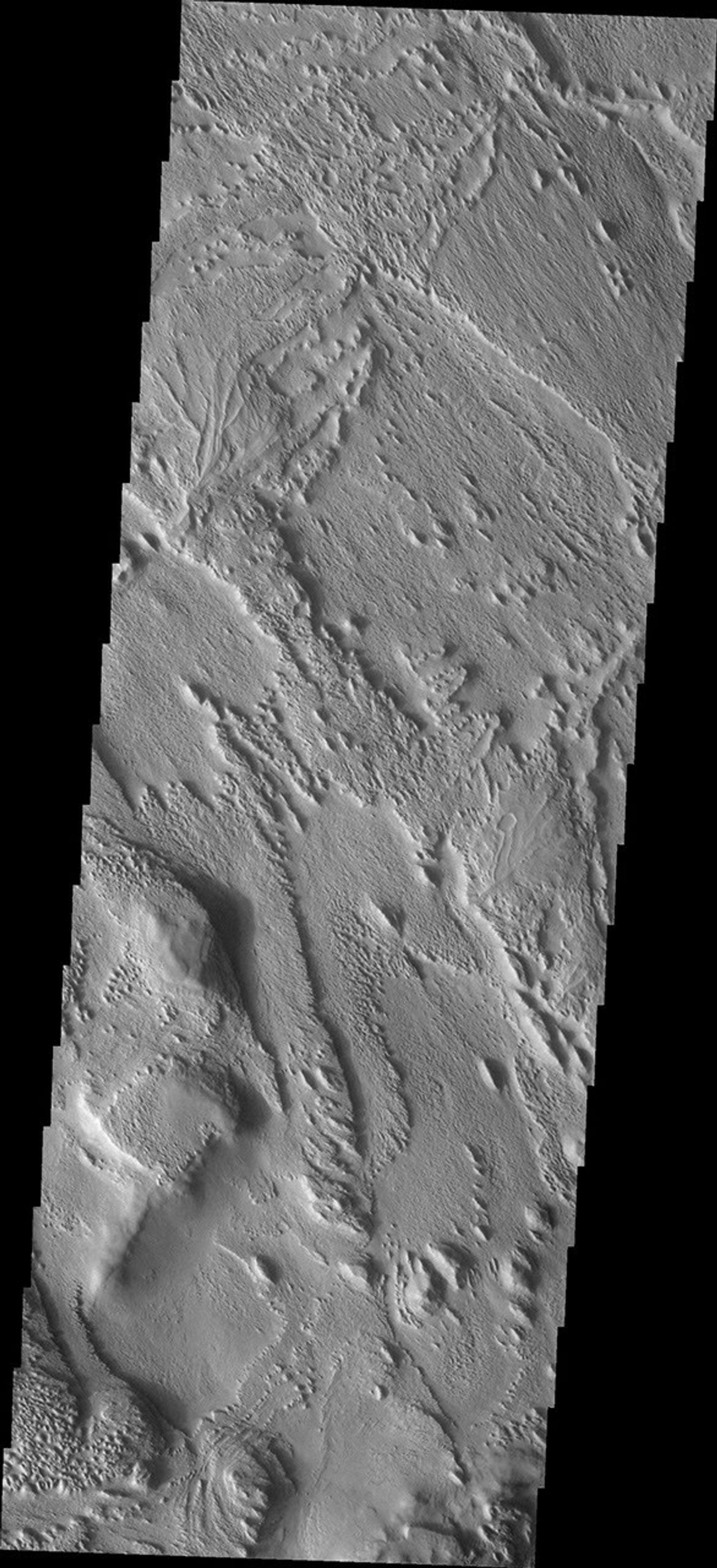 This image from NASA's Mars Odyssey shows a portion of the eastern side of Aeolis Planum. The region has been extensively eroded by the wind. Relics of an earlier surface are located in the central part of the image, in the form of inverted channels.