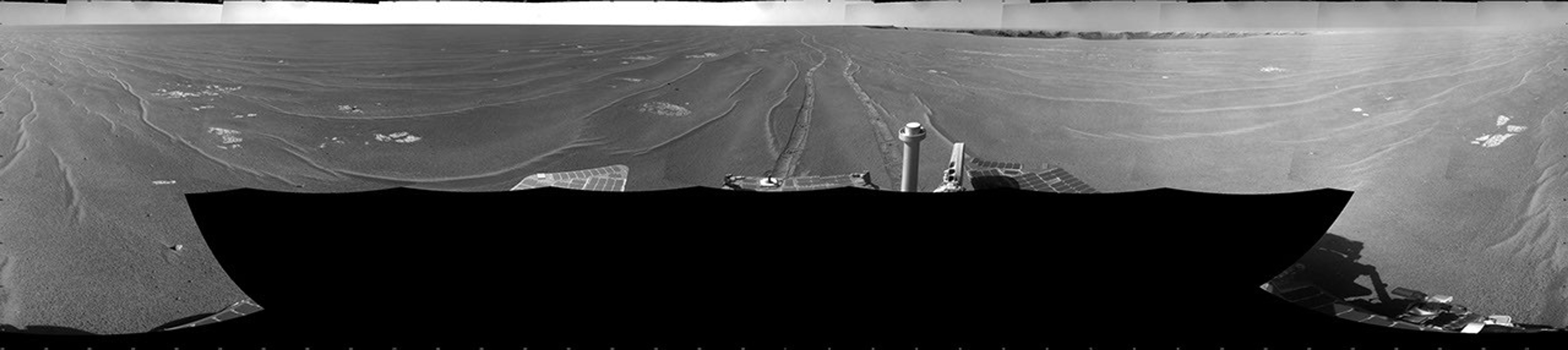 NASA's Mars Exploration Rover Opportunity took this full-circle view of the rover's surroundings on Sept. 28, 2008. The rover's parallel tracks are in view as is Victoria Crater.