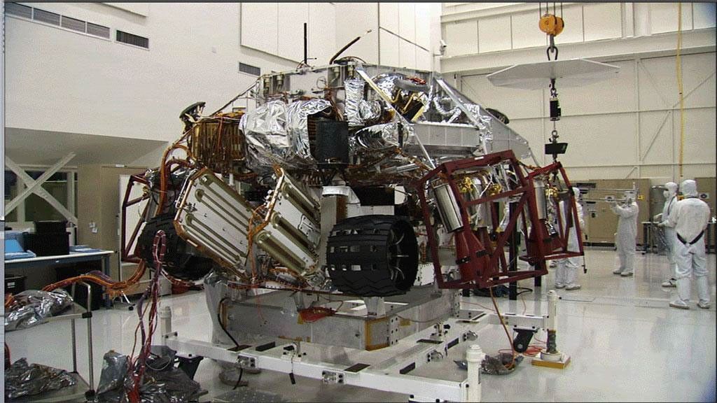 These three images show the progression of 'stacking' NASA's Mars Science Laboratory rover and its descent stage in one of NASA's Jet Propulsion Laboratory's 'clean room.'