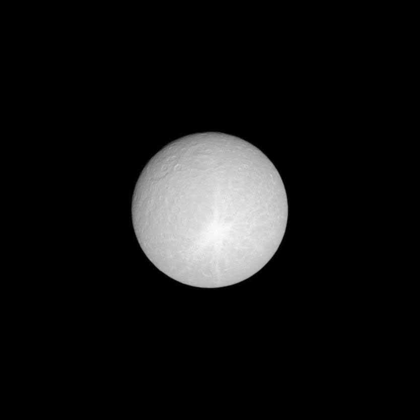 With streaks of icy material thrown in many directions, a huge ray crater stretches across nearly half of the leading hemisphere of Saturn's moon Rhea. This image was taken in visible light with NASA's Cassini spacecraft's narrow-angle camera.