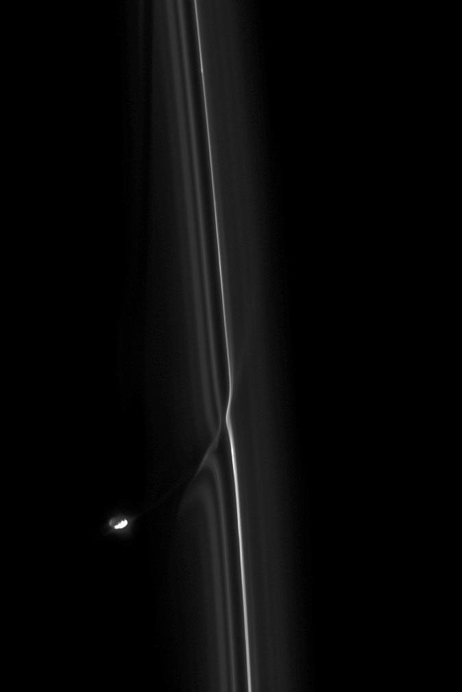 Saturn's moon Prometheus is seen here in its never-ending perturbation of Saturn's F ring in this image from NASA's Cassini spacecraft taken on March 12, 2009.