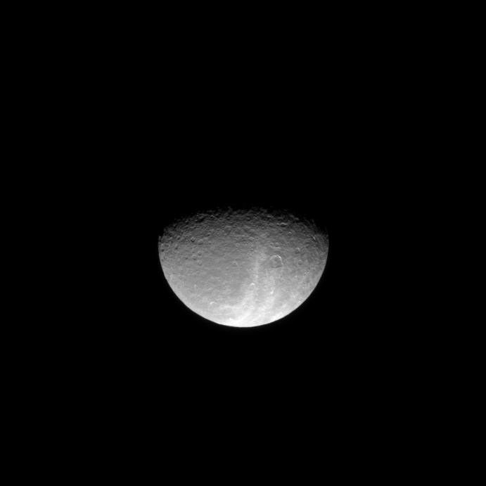 Bright light reflects off the wispy terrain of Saturn's moon Rhea in this image which looks down on the high northern latitudes of the icy moon. This image was taken in visible light with NASA's Cassini spacecraft's narrow-angle camera.