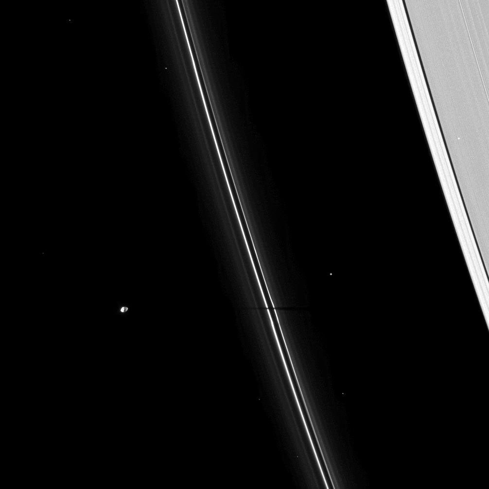 The thin shadow of the moon Pandora cuts across Saturn's narrow F ring, as seen by NASA's Cassini spacecraft on Apr. 16, 2009. As Saturn approaches its August 2009 equinox, the planet's moons cast shadows onto the rings.