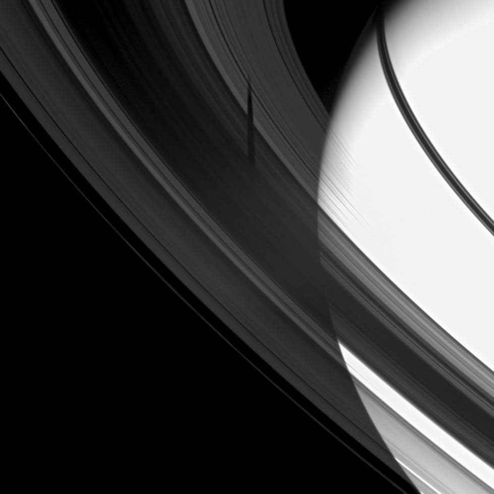The shadow of Saturn's icy moon Tethys is revealed on Saturn's B and C rings in this image from NASA's Cassini spacecraft which also includes the planet.
