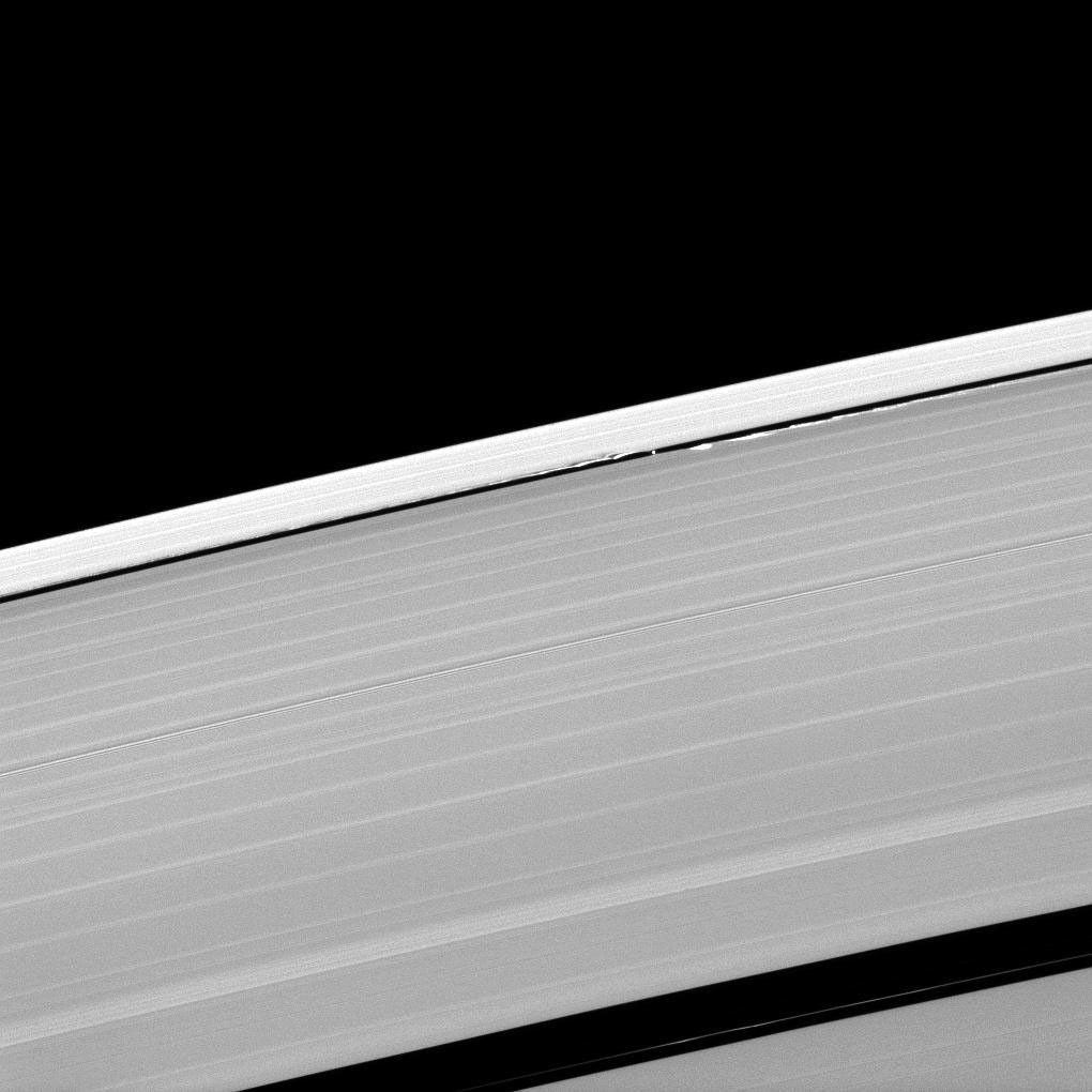 A scalloped look is created in the edges of the Keeler Gap in Saturn's outer A ring as the moon Daphnis orbits in the gap. This image is from NASA's Cassini spacecraft.