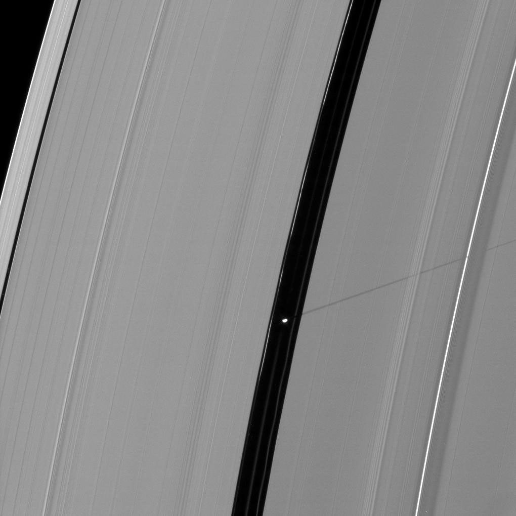 Saturn's moon Pan casts a longer shadow across the A ring as the planet's August 2009 equinox draws near. This image is from NASA's Cassini spacecraft.
