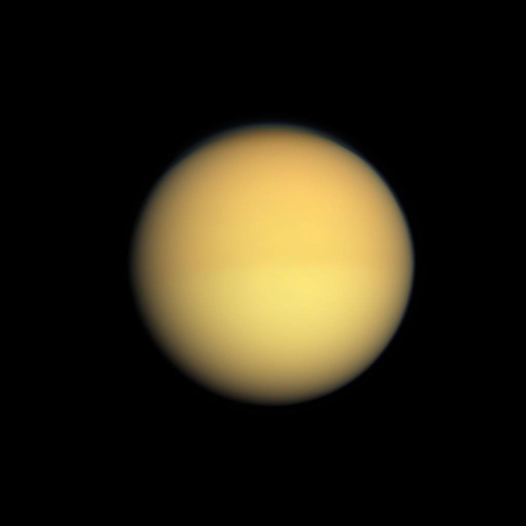 Seasonal changes in the atmosphere of Saturn's largest moon are captured by NASA's Cassini spacecraft, which shows Titan with a slightly darker top half and a slightly lighter bottom half.