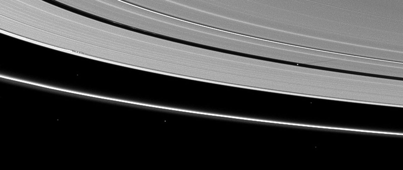 Moon shadows are cast on Saturn's A ring in this image taken by NASA's Cassini Orbiter almost a month after the planet's August 2009 equinox.