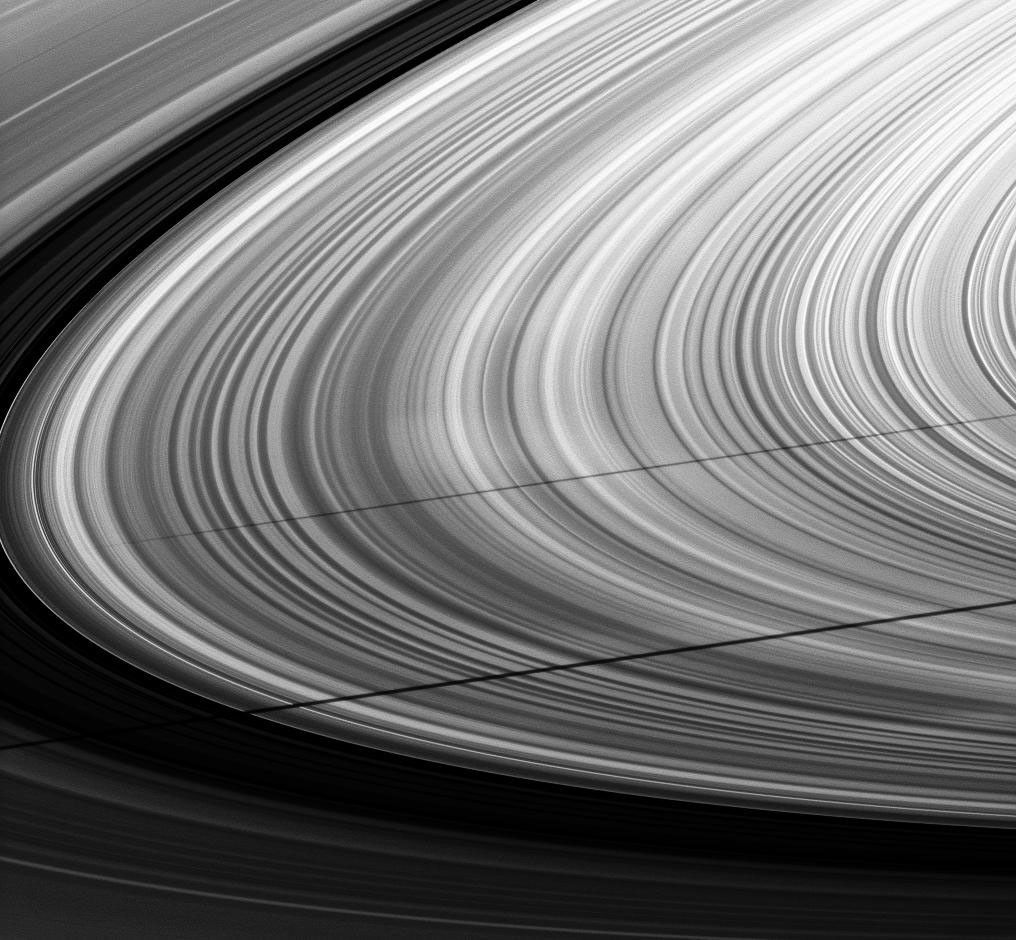 A pair of moon shadows and a series of spokes adorn this ring image taken about a month after Saturn's August 2009 equinox. The shadow of the moon Janus stretches across the middle of this image from NASA's Cassini spacecraft.