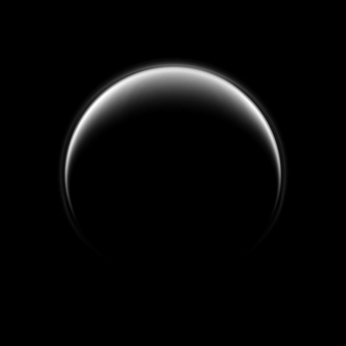 In this image, NASA's Cassini spacecraft looks down on the north pole of Titan, and, although this view is centered on the leading hemisphere of the moon, the lit terrain seen here is mostly on the opposite, trailing hemisphere of the moon.
