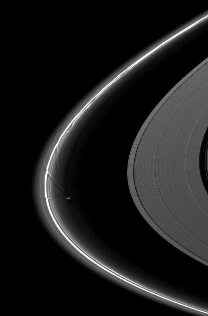 NASA's Cassini spacecraft captured Saturn's moon Prometheus, orbiting near the streamer-channels it has created in the thin F ring, casts a shadow on the A ring in this image taken a little more than a week after the planet's August 2009 equinox.