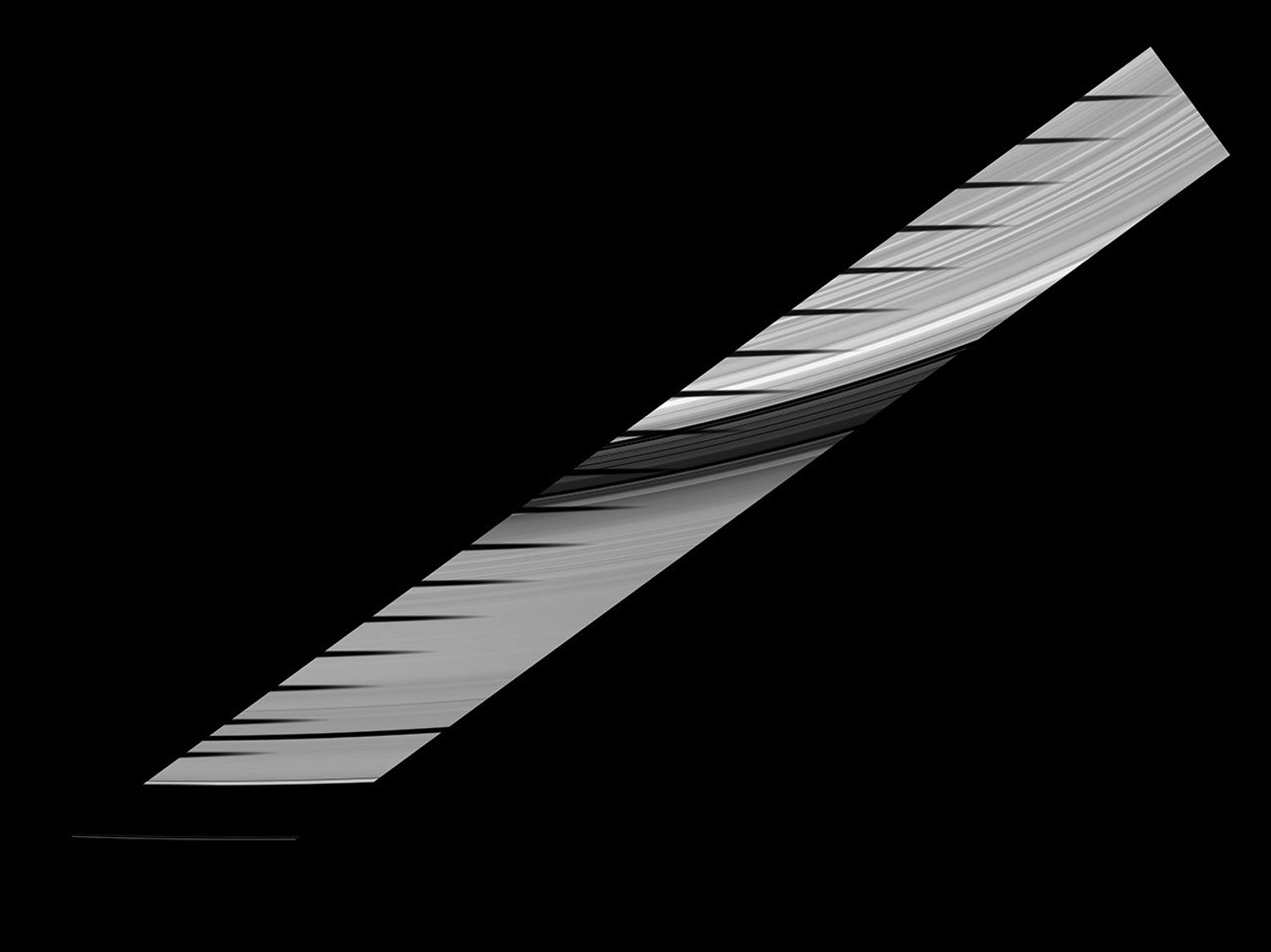 Mimas' shadow traverses the sunlit side of Saturn's rings in this image and mosaic showcasing the unusual sights seen by NASA's Cassini spacecraft at Saturn as the planet approaches its August 2009 equinox.
