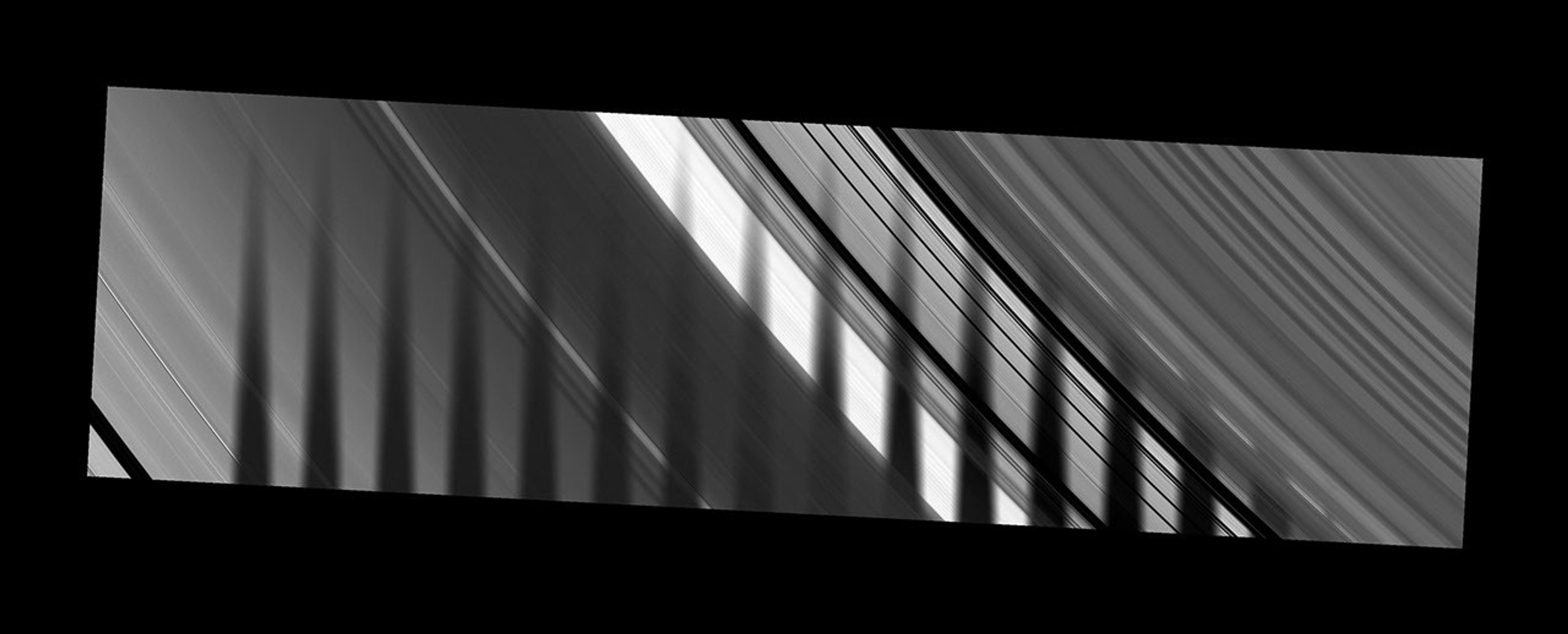 NASA's Cassini spacecraft captures the shadow of Saturn's moon Tethys as it seems to disappear as it crosses the planet's rings.