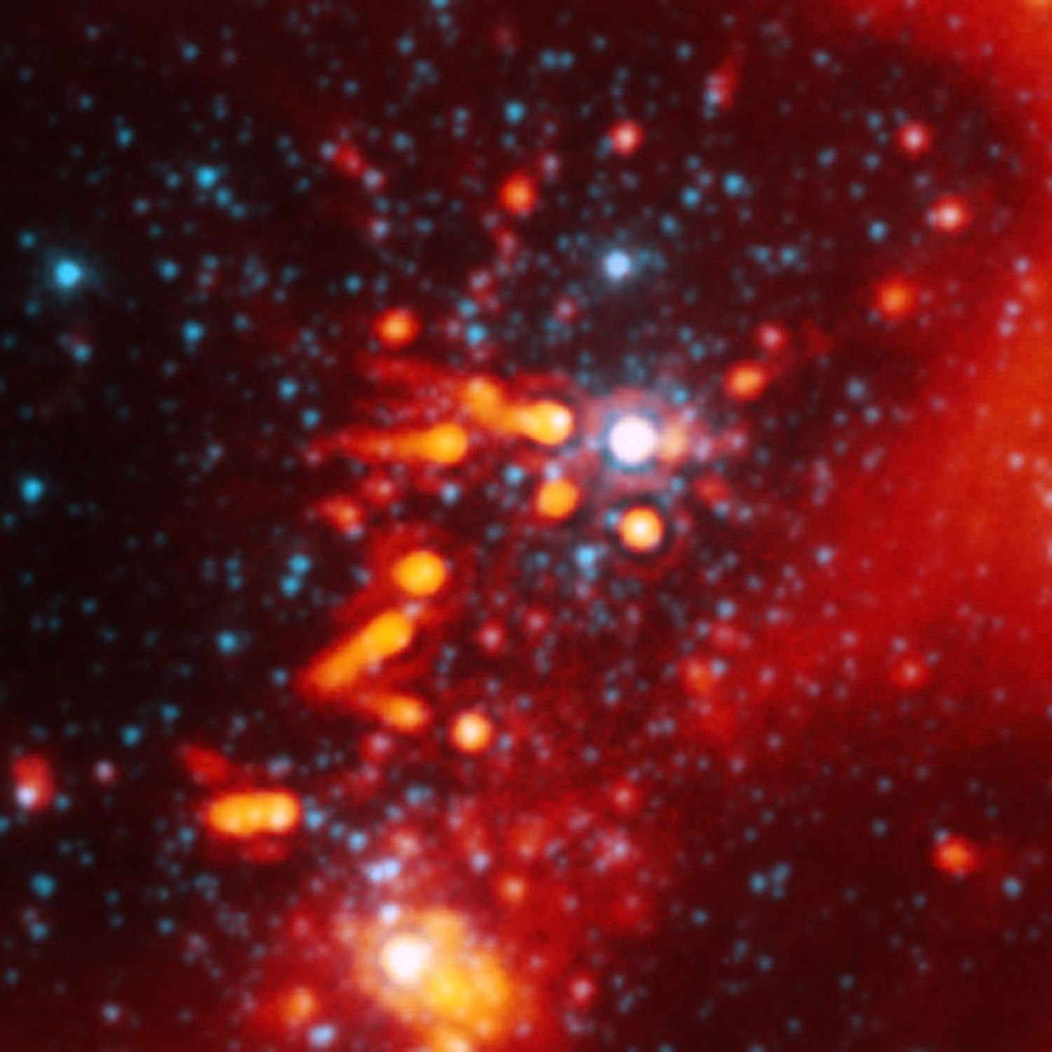 This image from NASA's Spitzer Space Telescope shows the nasty effects of living near a group of massive stars: radiation and winds from the massive stars (white spot in center) are blasting planet-making material away from stars like our sun.