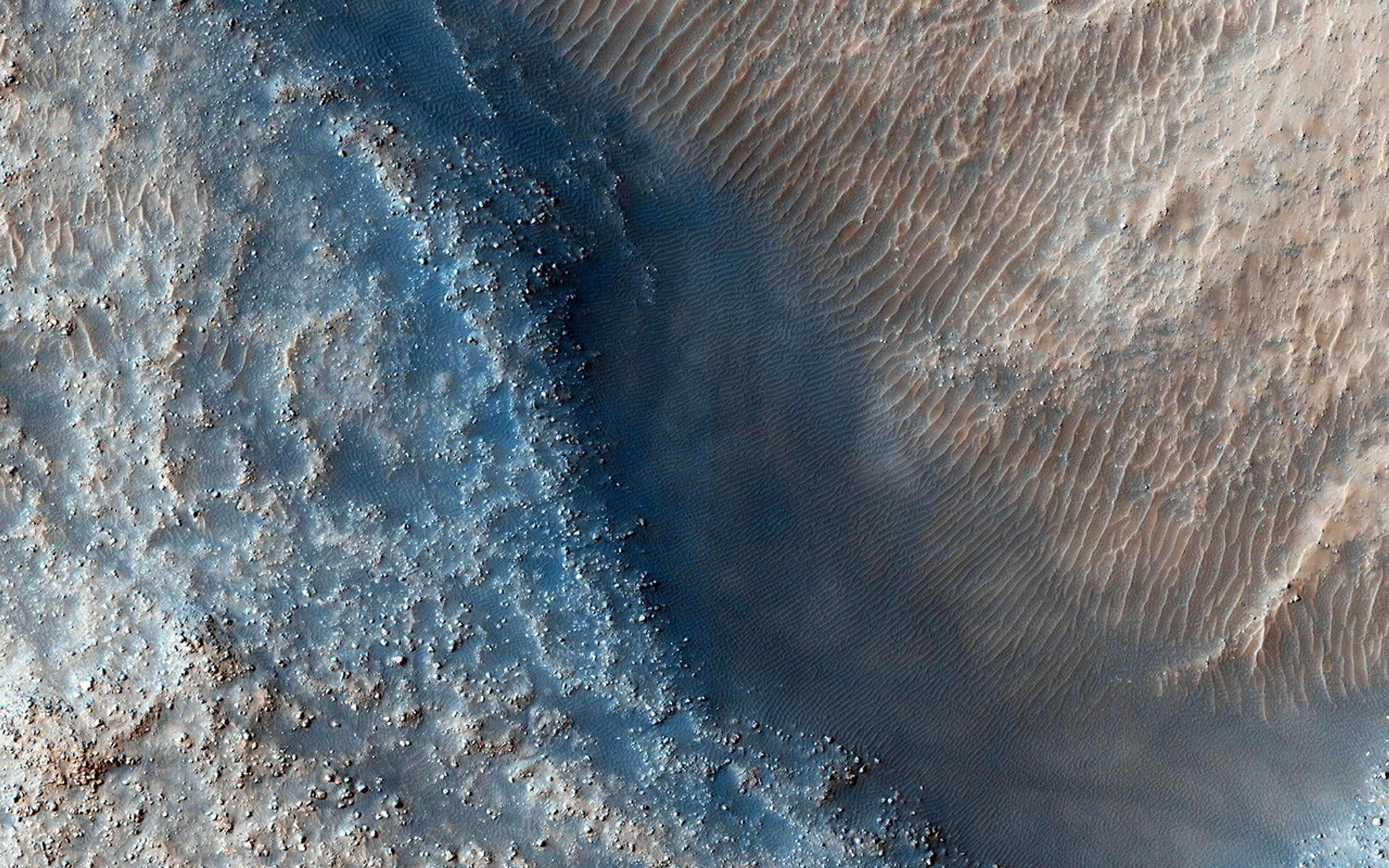 This observation from NASA's Mars Reconnaissance Orbiter targets some unknown fill or mantling material within valleys on a crater floor and within a central pit.
