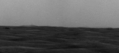 A western portion of Endeavour Crater is visible on the horizon of this image taken by NASA's Mars Exploration Rover Opportunity on March 7, 2009.