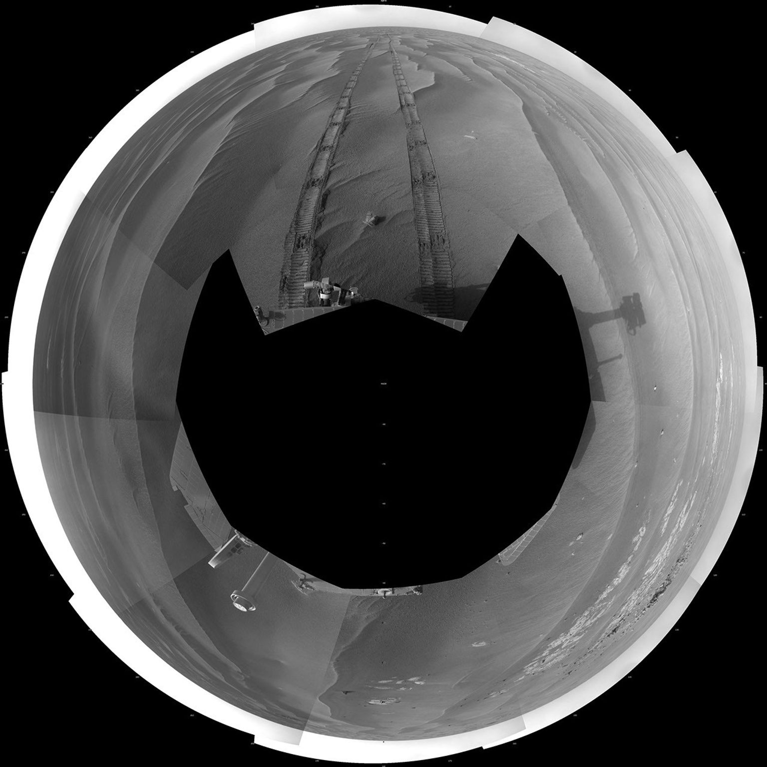 NASA's Mars Exploration Rover Opportunity took images combined into this polar full-circle view of Mars' Meridiani Planum region includes dark-toned sand ripples and small exposures of lighter-toned bedrock during March 5, 2009.