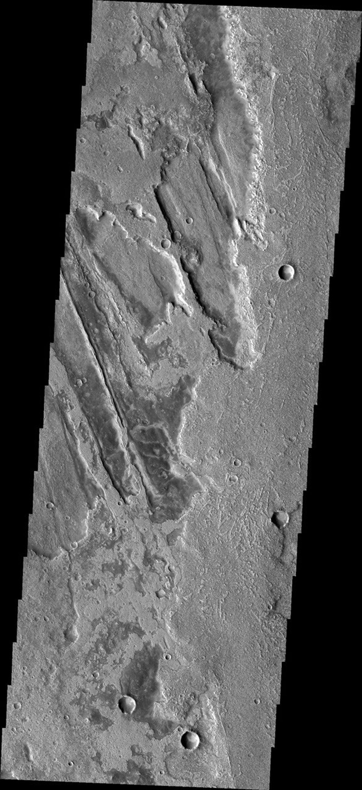 This image from NASA's Mars Odyssey shows southern Syria Planum featuring the complex relationship between the lava flows and the ridges and fractures of Claritas Fossae.