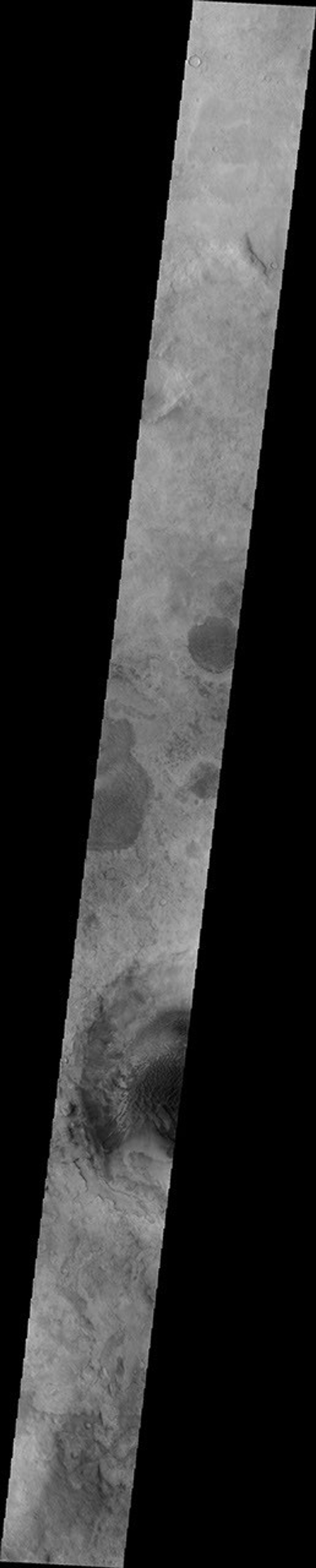 This image from NASA's Mars Odyssey shows part of Rabe Crater, featuring a portion of the dune field found on the floor of the crater on Mars. This image appears hazy due to the large amount of dust in the atmosphere from extensive dust storm activity.