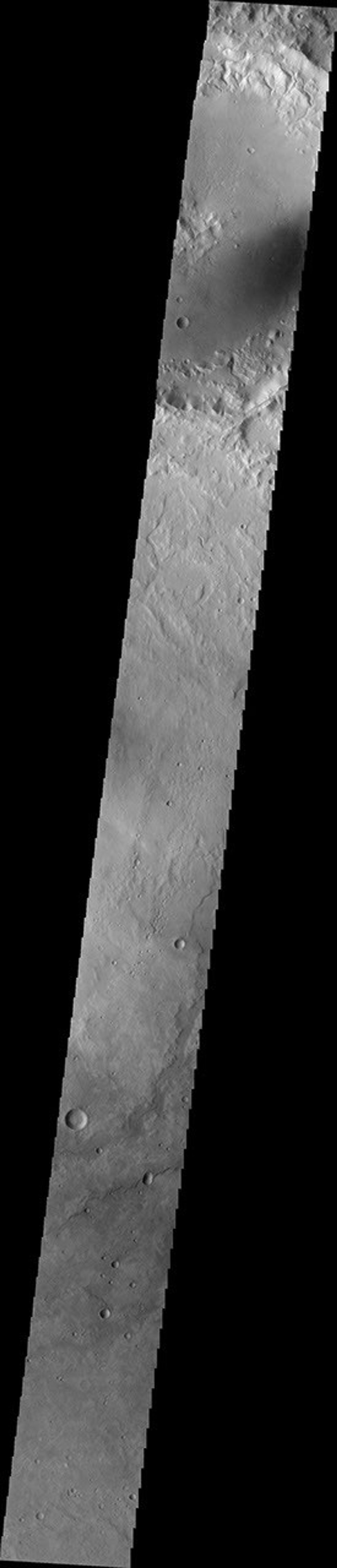 Channels dissect the northern rim of this unnamed crater in Terra Cimmeria on Mars as seen by NASA's Mars Odyssey spacecraft.