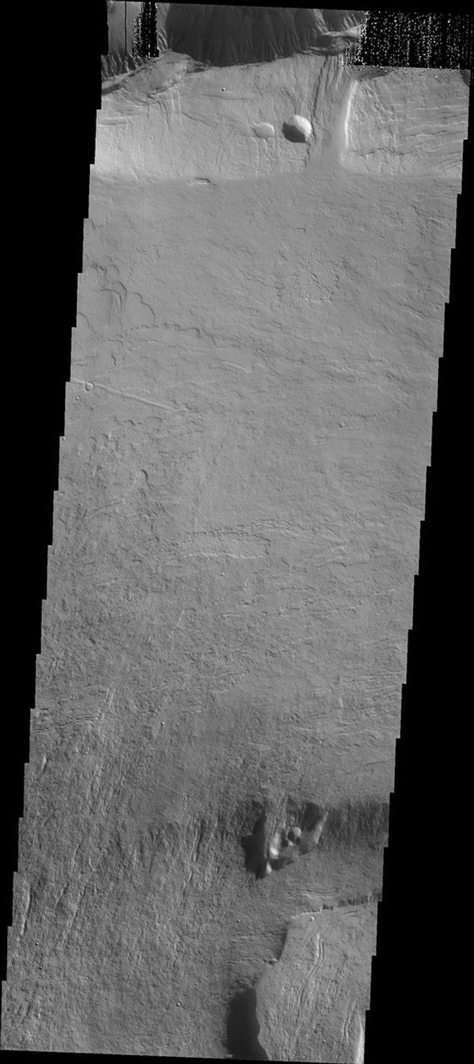 This image, taken by NASA's Mars Odyssey spacecraft, shows flow features on the northern flank of Olympus Mons.