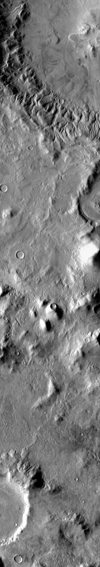 This daytime 2001 Mars Odyssey THEMIS infrared image clearly shows the multitude of channels dissecting the rim of Lipik Crater.