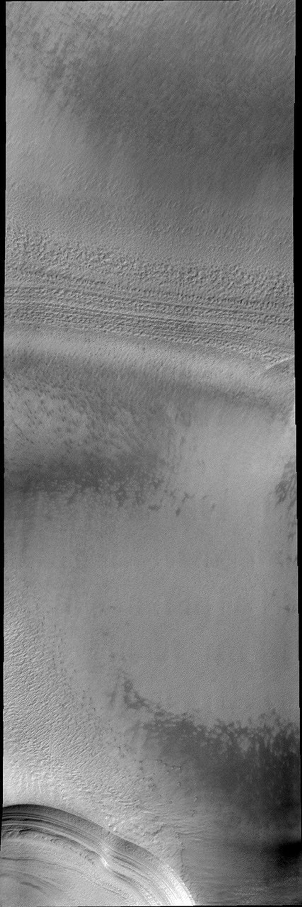 The numerous layers of Mars' south polar cap are shown in cross-section in this image from 2001 Mars Odyssey spacecraft.