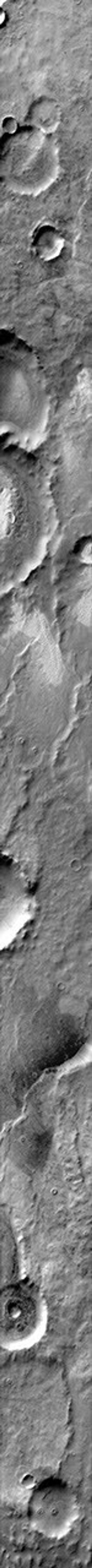This daytime 2001 Mars Odyssey image of Terra Cimmeria shows dunes occurring both on crater floors and on the plains between the craters on Mars.