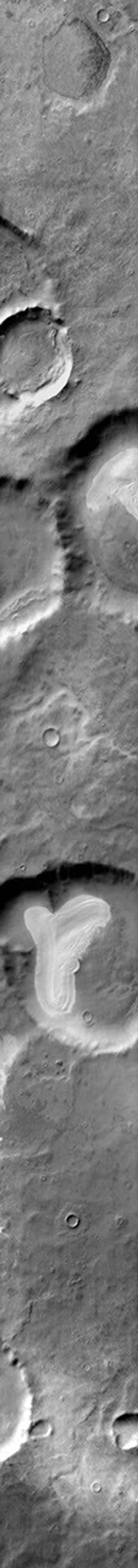 This daytime 2001 Mars Odyssey image of Promethei Terra shows bright dune sheets on the floor of two unnamed craters on Mars.