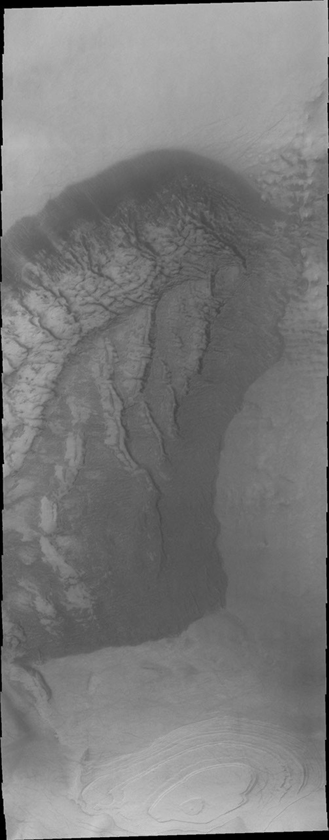 This 2001 Mars Odyssey image of Jeans Crater shows a sand sheet on Mars with dune forms and a layered region to the south of the sand sheet.