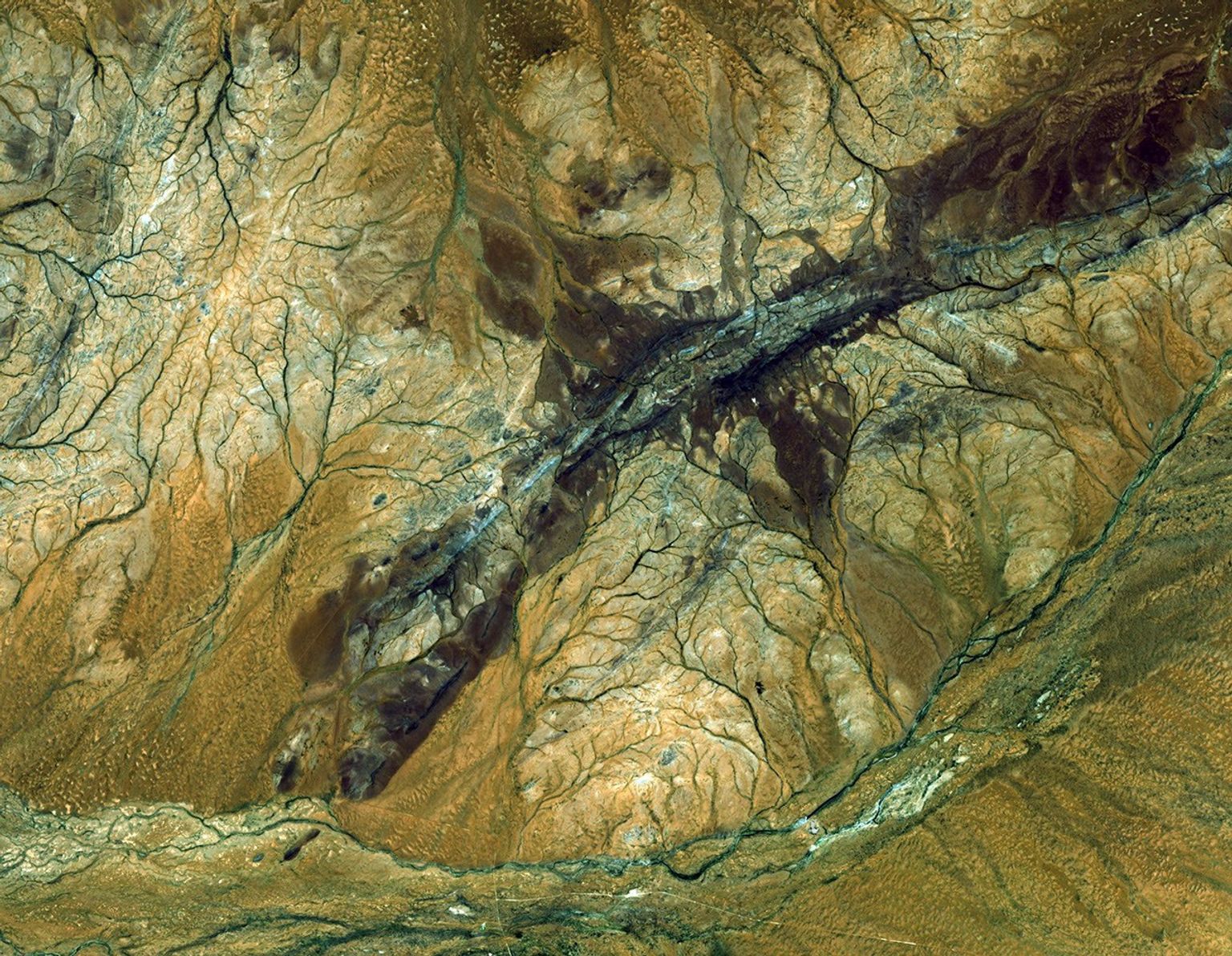 This image acquired by NASA's Terra spacecraft, shows the oldest material on Earth which has yet been dated by man is a zircon mineral of 4.4 billion years old from a sedimentary gneiss in the Jack Hills of the Narre Gneiss Terrane of Australia.