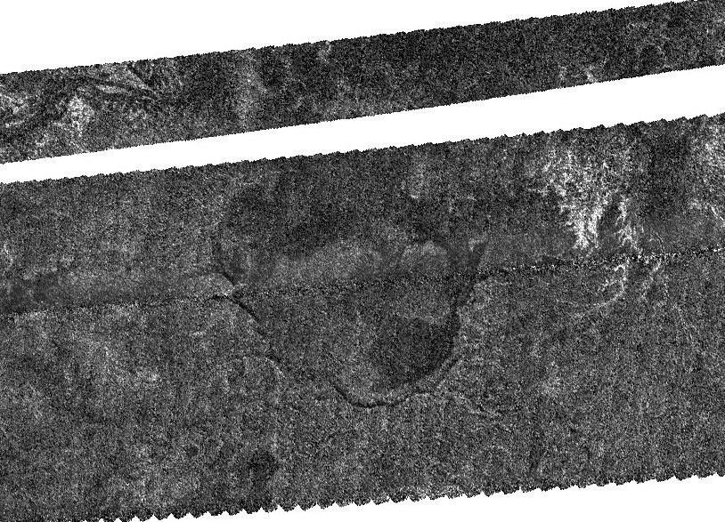 An enigmatic large basin appears in the south polar region of Saturn's moon Titan at the center of this Titan Radar Mapper image from NASA's Cassini spacecraft acquired on June 22, 2009.