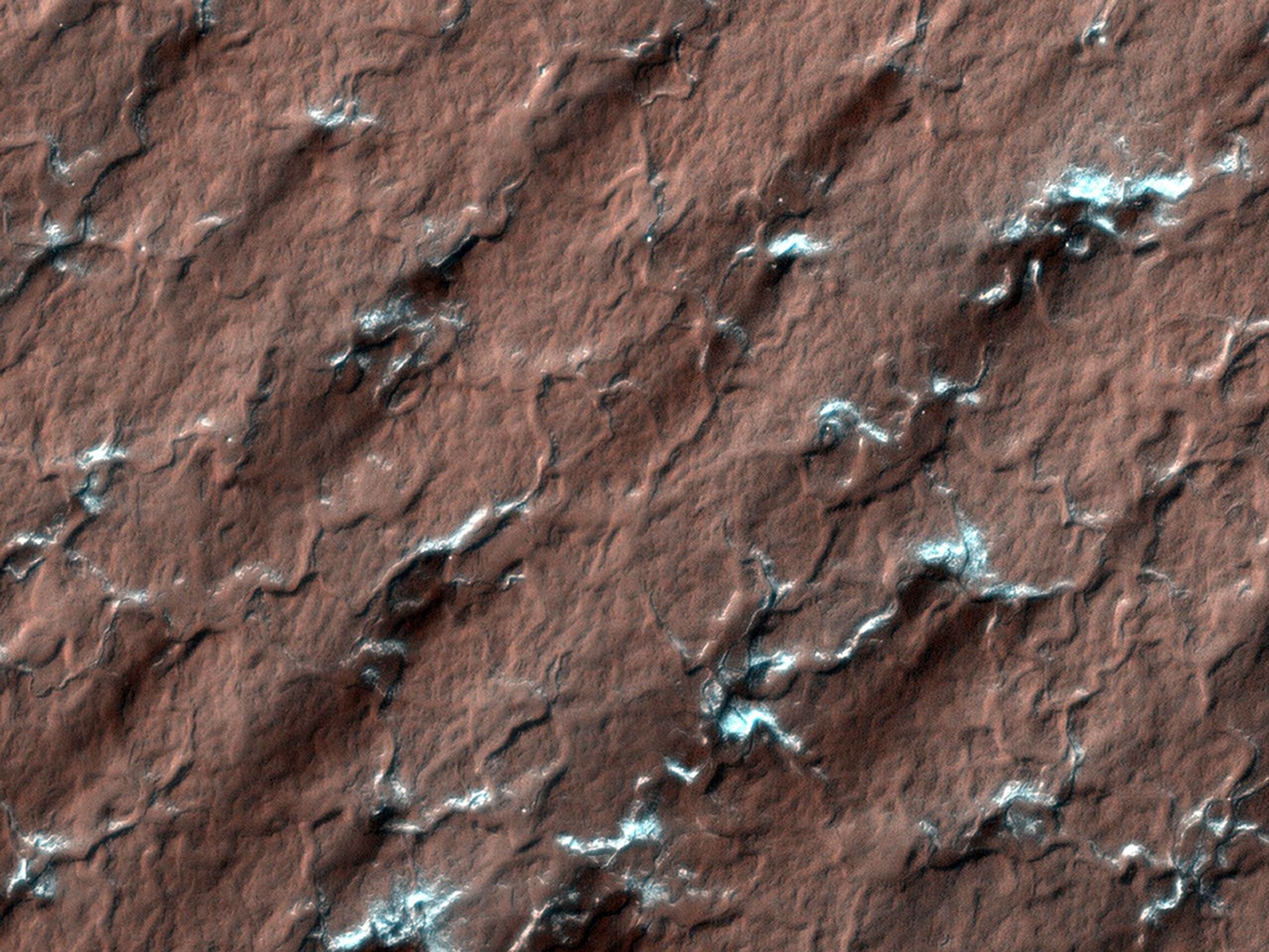 NASA's Mars Reconnaissance Rover spied these spider-like formations, likely caused as carbon dioxide ice changes from a solid to a gas; the gas moves through channels until it reaches the surface and vents out.