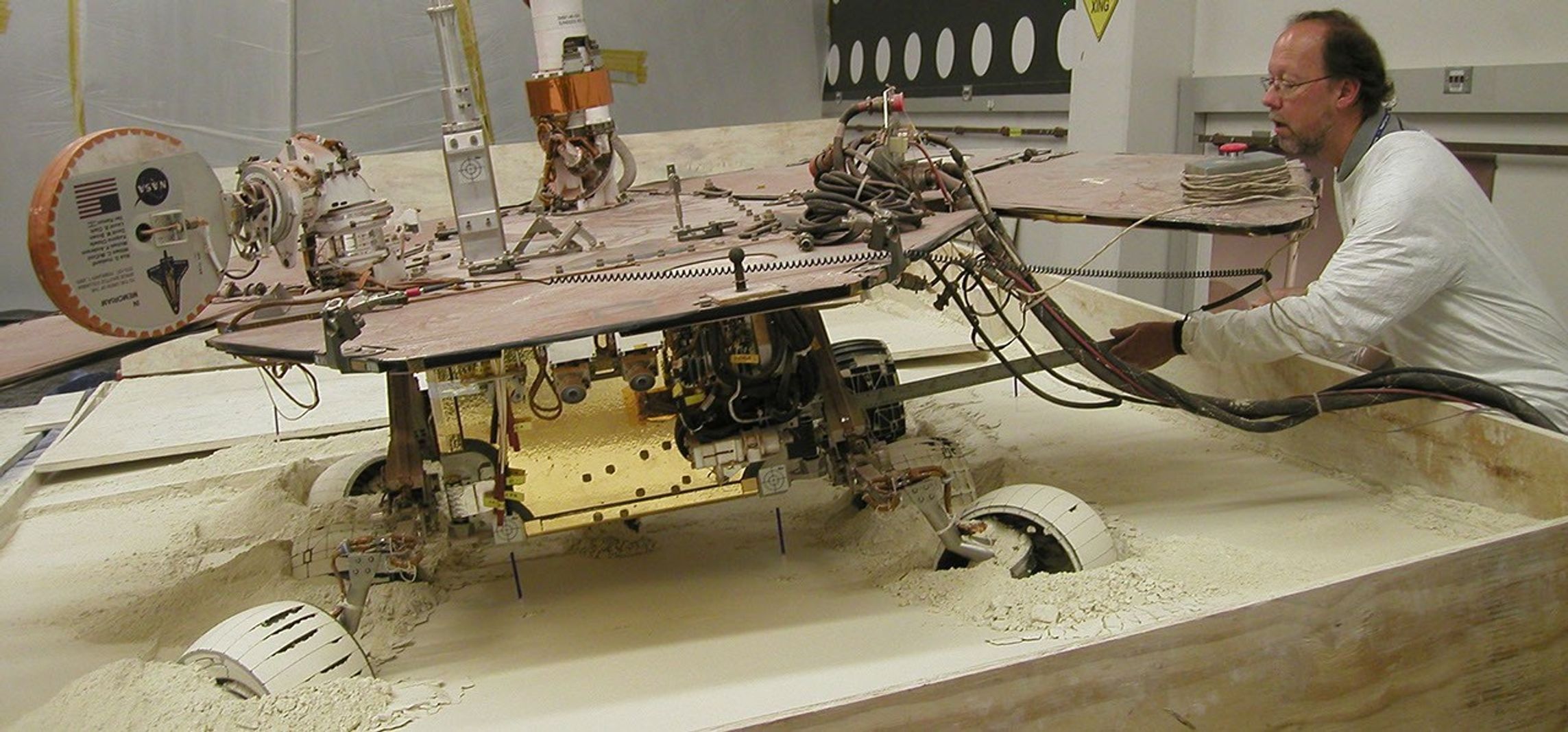 In this view from behind a test rover at NASA's Jet Propulsion Laboratory, Pasadena, Calif., the rear wheels of the rover are turned toward the left, and the left-front wheel is turned toward the right.