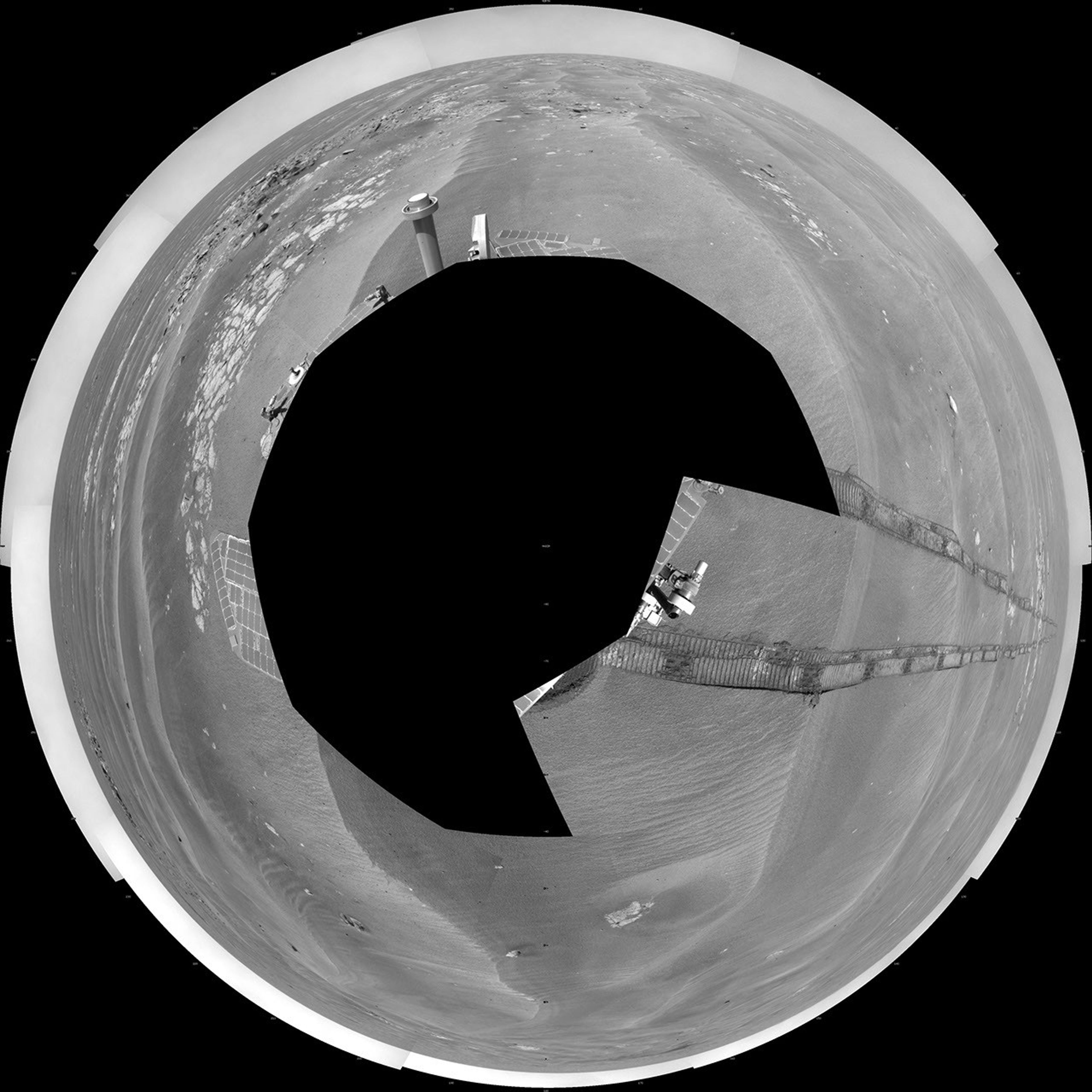 NASA's Mars Exploration Rover Opportunity used its navigation camera to take the images combined into this 360-degree polar view of the rover's surroundings on the 1,950th Martian day, or sol, of its surface mission (July 19, 2009).